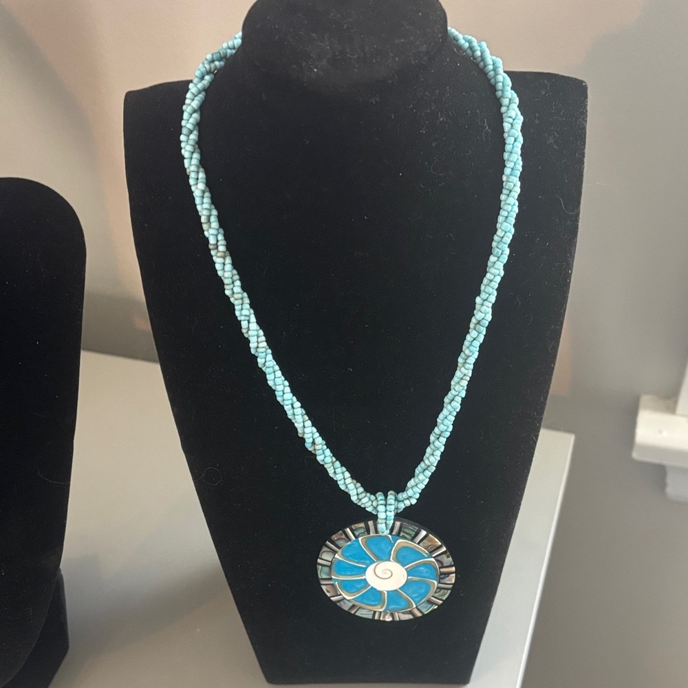 Turquoise beaded necklace with medallion.